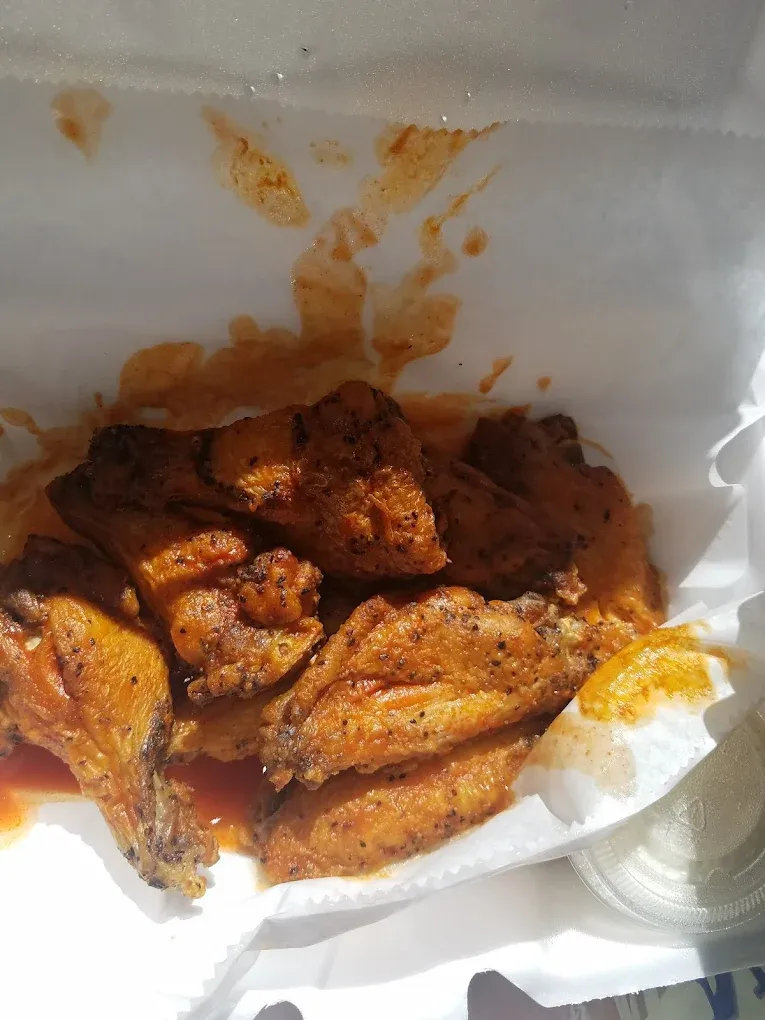 Chicken wings coated in lemon pepper seasoning.